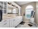 Bright bathroom featuring double sinks, white cabinets, a large mirror, and hexagon tile floors at 5299 W Pr Black Hawk, Edinburgh, IN 46124