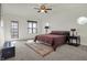 Spacious bedroom with a ceiling fan, natural light, and carpeted floors at 5299 W Pr Black Hawk, Edinburgh, IN 46124