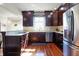 Well-lit kitchen featuring dark wood cabinets, stainless steel appliances, and granite countertops at 5299 W Pr Black Hawk, Edinburgh, IN 46124