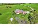 Aerial view of the home's rear exterior featuring a brick facade, fenced yard, and well-manicured lawn and mature trees at 5299 W Pr Black Hawk, Edinburgh, IN 46124