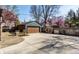 Large concrete area backyard with brick building and basketball hoop, bordered by privacy fence and mature trees at 5331 N New Jersey St, Indianapolis, IN 46220