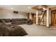 Spacious finished basement with a sectional sofa and carpeted floors at 5331 N New Jersey St, Indianapolis, IN 46220