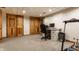 Functional basement office space featuring a desk, carpet flooring, and ample storage at 5331 N New Jersey St, Indianapolis, IN 46220