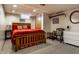 Basement bedroom with carpet, red bedding, and a light-colored ceiling at 5331 N New Jersey St, Indianapolis, IN 46220