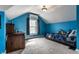 Cozy bedroom with blue walls, featuring a twin bed, desk, and large window at 5331 N New Jersey St, Indianapolis, IN 46220
