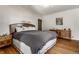 Charming bedroom with hardwood floors, wood furniture, a grey comforter, and art on the wall at 5331 N New Jersey St, Indianapolis, IN 46220