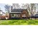 Charming brick home featuring a beautifully landscaped front yard and enclosed sunroom at 5331 N New Jersey St, Indianapolis, IN 46220