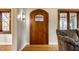 Elegant foyer featuring a wooden front door, hardwood floors, and charming architectural details at 5331 N New Jersey St, Indianapolis, IN 46220