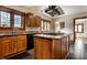 Modern kitchen featuring granite countertops, an island cooktop, and stainless steel range hood at 5331 N New Jersey St, Indianapolis, IN 46220