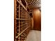 A traditional wood wine cellar featuring wood plank walls, carpet, and wine racks filled with various bottles at 5331 N New Jersey St, Indianapolis, IN 46220