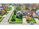 Aerial view showcasing a well-maintained home with lush green lawns, mature trees, and a charming neighborhood setting at 5549 Dill Ct, Indianapolis, IN 46237