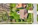 Aerial view showcases the home's roof and the backyard featuring lush green lawn and a charming patio area at 5549 Dill Ct, Indianapolis, IN 46237