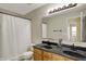 Bathroom with a double sink vanity, large mirror, and a shower with a curtain at 5549 Dill Ct, Indianapolis, IN 46237