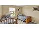 Cozy bedroom featuring neutral walls, two twin beds with stylish gray and white bedding, and a window for natural light at 5549 Dill Ct, Indianapolis, IN 46237