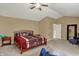 Spacious bedroom featuring a large bed, ceiling fan, neutral walls, and plush carpeting at 5549 Dill Ct, Indianapolis, IN 46237