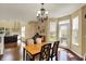 Inviting dining area with hardwood floors, chandelier, and natural light. The dining area is located near the kitchen and living room at 5549 Dill Ct, Indianapolis, IN 46237