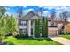 Two-story home with attached garage, well-maintained lawn, and tall evergreen trees in the front yard at 5549 Dill Ct, Indianapolis, IN 46237