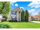 Landscaped front yard with brick and siding two-story home, mature trees, and an attached garage at 5549 Dill Ct, Indianapolis, IN 46237