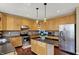 Spacious kitchen with stainless steel appliances, granite countertops, and wood cabinetry at 5549 Dill Ct, Indianapolis, IN 46237