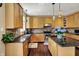 Spacious kitchen featuring granite counters, wood cabinets, stainless appliances, and a central island, perfect for cooking and entertaining at 5549 Dill Ct, Indianapolis, IN 46237