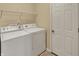 Functional laundry room with a washer, dryer, and shelving, providing a convenient space for laundry tasks at 5549 Dill Ct, Indianapolis, IN 46237