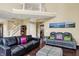 Spacious living room with a staircase, comfortable couches, and ample natural light, creating an inviting atmosphere at 5549 Dill Ct, Indianapolis, IN 46237