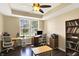Spacious home office with natural light, a built-in bookcase, and ample space for multiple workstations at 5549 Dill Ct, Indianapolis, IN 46237