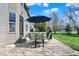 Charming patio with a round table, four chairs, umbrella, and grill, perfect for outdoor entertaining at 5549 Dill Ct, Indianapolis, IN 46237