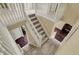 Grand staircase with white railings and carpeted steps, connecting the upper and lower levels of the home with elegance at 5549 Dill Ct, Indianapolis, IN 46237