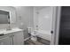 Bathroom featuring a shower and tub combination, a toilet and a white vanity at 5636 W Henry St, Indianapolis, IN 46241