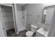 A simple bathroom includes a shower, single sink vanity, and towel and toilet paper holders at 5636 W Henry St, Indianapolis, IN 46241