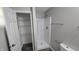 This bathroom includes a standing shower and closet, with neutral walls, and updated fixtures and hardware at 5636 W Henry St, Indianapolis, IN 46241