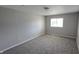 Carpeted bedroom with a window, painted in a soothing neutral tone, and electrical outlets at 5636 W Henry St, Indianapolis, IN 46241