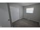 A bedroom features a closet, a window, and neutral walls and flooring for versatile styling at 5636 W Henry St, Indianapolis, IN 46241