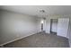 Cozy bedroom with neutral carpet, closet, and doorway view to a brightly lit hallway at 5636 W Henry St, Indianapolis, IN 46241