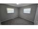 Bedroom with two windows allowing natural light, neutral walls, and carpet flooring at 5636 W Henry St, Indianapolis, IN 46241