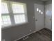 The entryway features a window, front door with decorative windows, and a second door leading into the home at 5636 W Henry St, Indianapolis, IN 46241