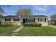 Charming ranch-style house with a well-maintained lawn and mature tree at 5636 W Henry St, Indianapolis, IN 46241