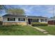 Charming single-story home featuring a well-maintained lawn and inviting walkway to the front door at 5636 W Henry St, Indianapolis, IN 46241