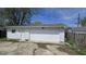 Detached one car garage with white siding under a sunny blue sky at 5636 W Henry St, Indianapolis, IN 46241