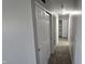 A hallway with a closet and overhead lighting leads to the rest of the living spaces at 5636 W Henry St, Indianapolis, IN 46241