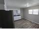 Bright kitchen with white cabinets, black countertops, and stainless steel sink under a window at 5636 W Henry St, Indianapolis, IN 46241