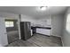 Modern kitchen featuring stainless steel appliances, white cabinets, and wood-look flooring at 5636 W Henry St, Indianapolis, IN 46241