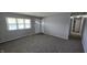 Neutral living room with carpet, closet, and a bright window offering ample natural light at 5636 W Henry St, Indianapolis, IN 46241