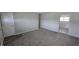 An open-concept living room features neutral carpet, paint, and a doorway that leads into another room at 5636 W Henry St, Indianapolis, IN 46241