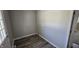 Well lit mud room with wood-look flooring, utility connection, and exterior door at 5636 W Henry St, Indianapolis, IN 46241