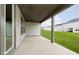 Covered back porch offers a relaxing outdoor space overlooking the grassy backyard at 5661 Stetson Dr, Whitestown, IN 46052