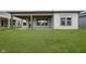 Lush green backyard with covered porch perfect for outdoor entertaining and relaxation at 5661 Stetson Dr, Whitestown, IN 46052
