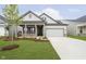 Charming home with landscaped yard, covered porch, and two-car garage offers great curb appeal at 5661 Stetson Dr, Whitestown, IN 46052