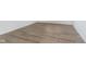 Close-up of durable and stylish light brown hardwood flooring with white trim along the base of the wall at 5661 Stetson Dr, Whitestown, IN 46052